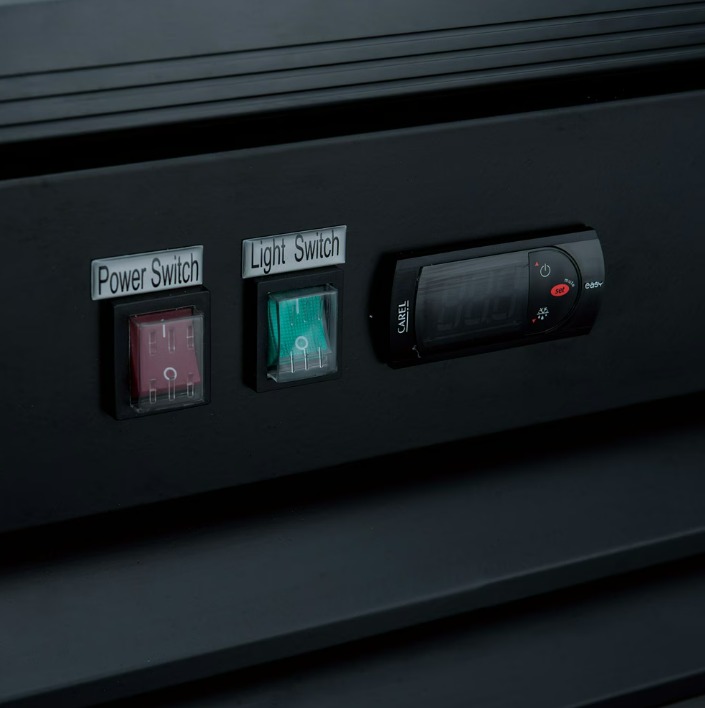 Two labeled switches on the back of a commercial refrigerator. The labels read "Power Switch" and Light Switch".